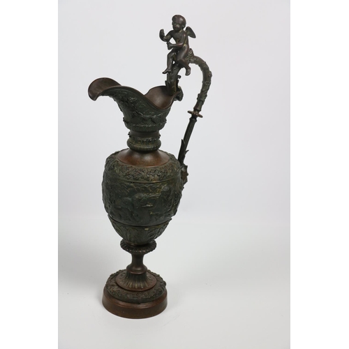 677 - A 19th Century bronze and gilt Ewer, in the Neo-classical style with cherubs and trailing vines in r... 