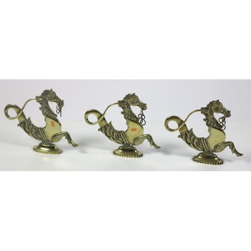 68 - A good set of heavy brass models of Sea Horses, a collection of attractive brass fittings, curtain t... 