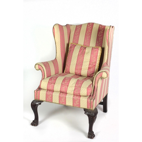 701 - An attractive 19th Century mahogany framed wing back Armchair, covered in pink and cream striped fab... 