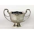 An attractive heavy silver two handled Bowl, with shaped and partly pierced rim, and half reeded bod... 