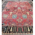 A fine quality Persian 20th Century claret ground Carpet, with a large floral decorated centre, and ... 