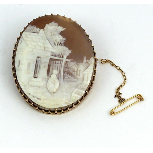 115 - A very fine gold carved Cameo Brooch, of a woman standing outside a house, with safety chain. (1)