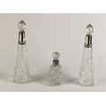 A small pair of silver mounted cone shaped cutglass Decanters & Stoppers; also another small silver ... 