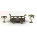 Two small white metal (Indian silver) two handled Cups, and a two bottle Table Coaster modelled as a... 