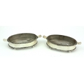 An attractive pair of oval shaped glass lined silver Butter Dishes, with two forks. (4)Provenance: T... 