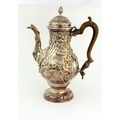 A very fine early George III heavy silver Coffee / Chocolate Pot, of baluster form with embossed dec... 