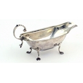A small unusual English silver Cream Jug, with gadroon edge, shell decorated handle on four pad feet... 