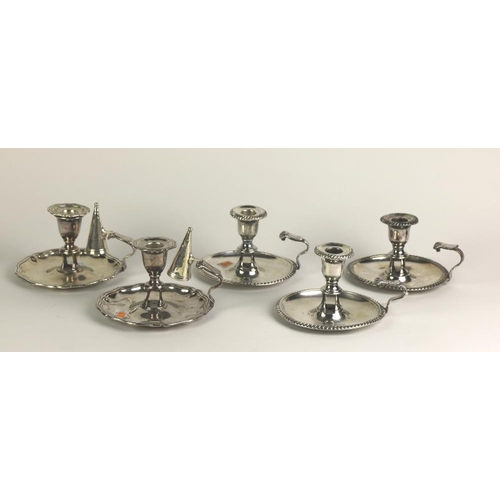 8 - A set of three early 19th Century Chamber Candlesticks, with shaped handles, each with gadroon edges... 