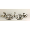 A set of three early 19th Century Chamber Candlesticks, with shaped handles, each with gadroon edges... 