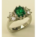 An elegant three stone Ring, set with emerald cut 
