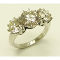 An attractive three stone diamond Ring, set in white gold (5.7g), the central stone (2ct) each side ... 