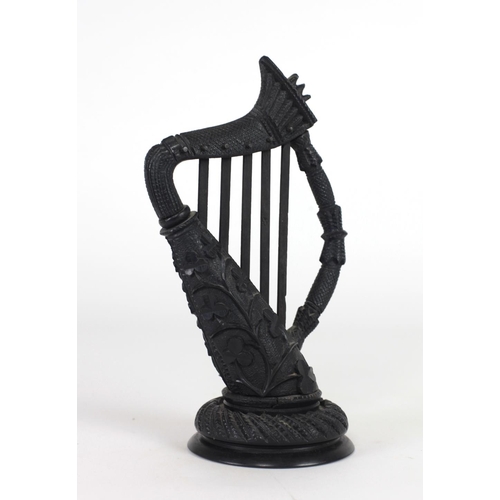 114 - A very well carved 19th Century bog-oak Harp, decorated with shamrocks, 25cms (9 3/4