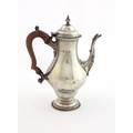 A Georgian style silver baluster shaped Coffee Pot, the hinged lid with plain finial and gadroon edg... 