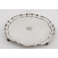 An early 20th Century large silver Salver, with piecrust edge on scroll feet, with monogram engraved... 