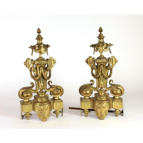 773 - A pair of tall 19th Century French gilt bronze Chenets, decorated in the Adams taste with pineapple ... 