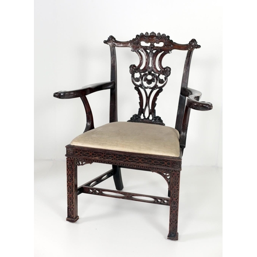 781 - An 18th Century Irish style mahogany Armchair, the pierced decorated splat back with S scroll arms t... 