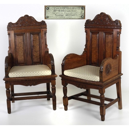 796 - A pair of large late Victorian pitch pine carved Armchairs, in the style of Jas. Shoolbred, the pane... 