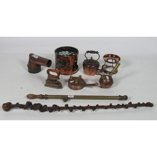 1005 - A varied collection of antique copper and brass vessels, funnels, measures etc., some interesting it... 