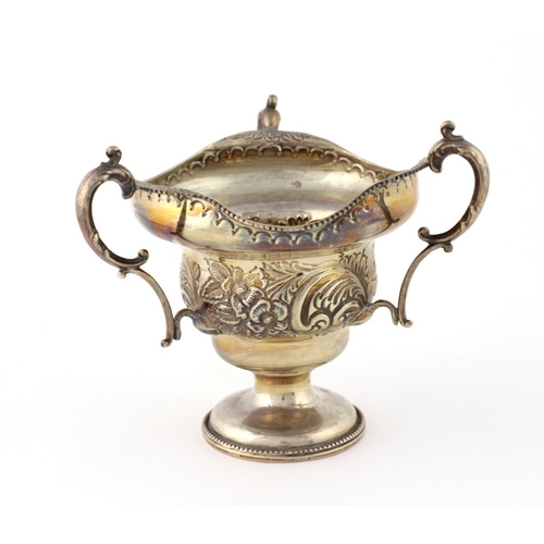 30 - An unusual Birmingham silver three handled Bowl, with floral embossed body c. 1906, on circular base... 