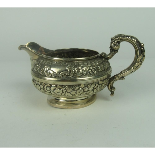 31 - A heavy early William IV Irish silver Cream Jug, with embossed floral body possibly by C. March  Dub... 