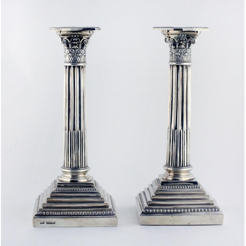 49 - A pair of 20th Century English silver Corinthian Pillar Candlesticks, by Walker & Hall, Sheffield 19... 