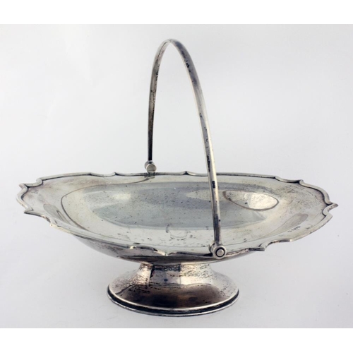 50 - A plain English silver swing handle Basket, with shaped rim, and on an oval foot, Chester c. 1910, a... 