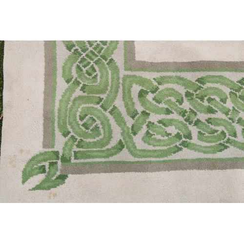 142 - A fine hand-tufted Donegal Carpet, the beige ground with a large attractive Celtic designed border o... 