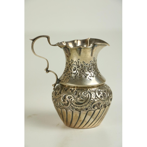 177 - An unusual Birmingham silver three handled Bowl, with floral embossed body c. 1906, on circular base... 