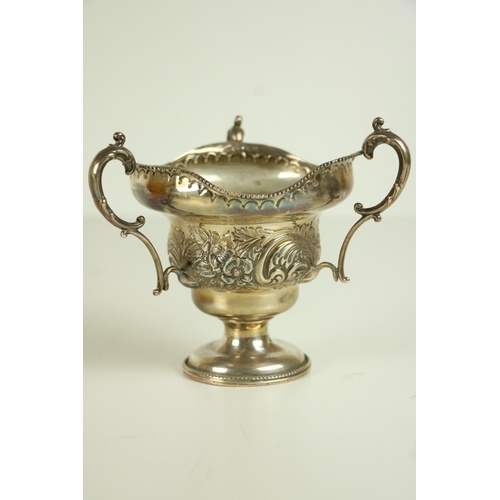 177 - An unusual Birmingham silver three handled Bowl, with floral embossed body c. 1906, on circular base... 