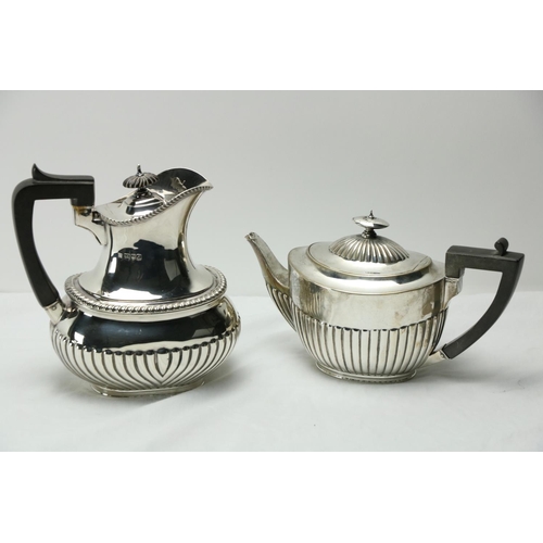 179 - A silver Hot Water Pot, with half reeded oval body and gadroon edge with ebonised wooden handle, 656... 