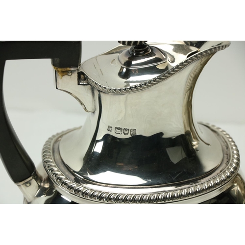 179 - A silver Hot Water Pot, with half reeded oval body and gadroon edge with ebonised wooden handle, 656... 