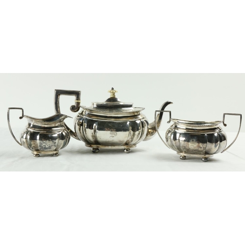 180 - A three piece silver Tea Service, Chester c. 1900, comprising ogee shaped teapot with gadroon edge o... 