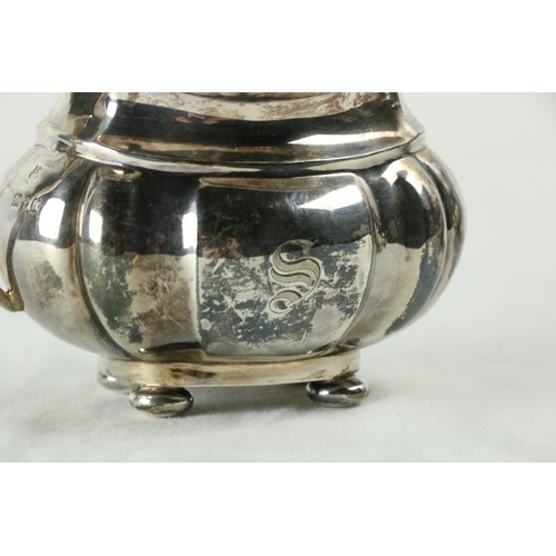 180 - A three piece silver Tea Service, Chester c. 1900, comprising ogee shaped teapot with gadroon edge o... 