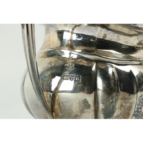 180 - A three piece silver Tea Service, Chester c. 1900, comprising ogee shaped teapot with gadroon edge o... 