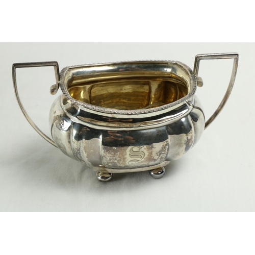 180 - A three piece silver Tea Service, Chester c. 1900, comprising ogee shaped teapot with gadroon edge o... 