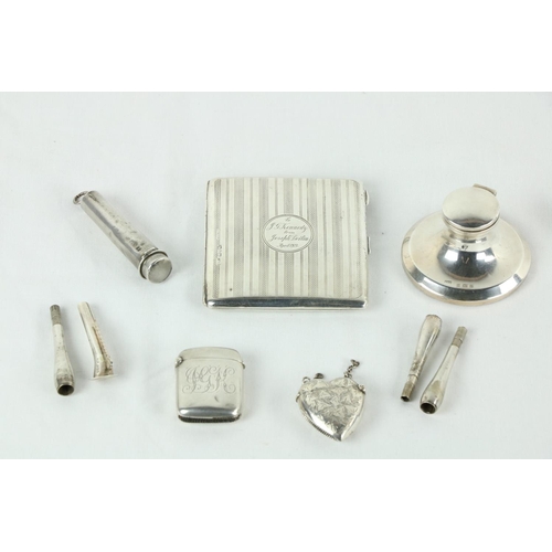 183 - A machine turned silver stamp and Sovereign Purse, Chester 1920, a silver heart shaped Vesta Case, a... 