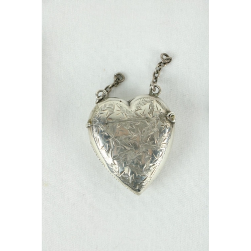 183 - A machine turned silver stamp and Sovereign Purse, Chester 1920, a silver heart shaped Vesta Case, a... 