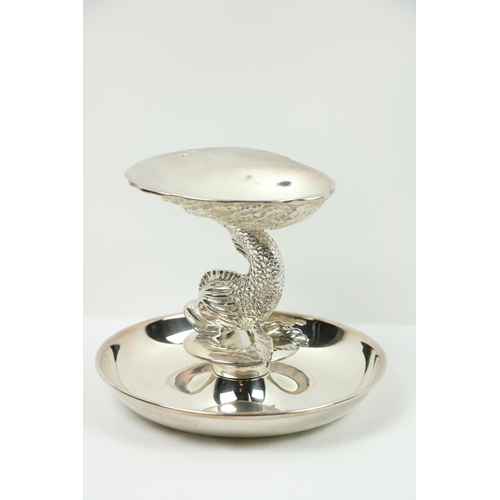 195 - An attractive silver scallop Dish, modelled as a half shell supported on a conforming dolphin with a... 