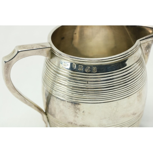 208 - A late George III Scottish silver Cream Jug, Edinburgh 1814, the barrel shaped body with a shaped ha... 