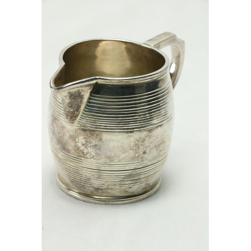 208 - A late George III Scottish silver Cream Jug, Edinburgh 1814, the barrel shaped body with a shaped ha... 