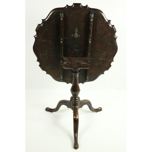 480 - A 19th Century mahogany flip top Table, with circular recurving pie-crust top on baluster pod and tr... 