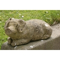 A pair of small weathered composition models, of recumbent Piglets, 53cms long (21