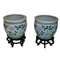 A pair of large modern Chinese Fish Bowls, decorated with stylized flowers on hardwood stands, overa... 