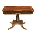 An attractive Regency period fold-over rosewood and brass inlaid Card Table, on upward square taperi... 
