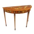 A George III mahogany demi-lune Side Table, profusely decorated with a centre urn issuing garlands o... 