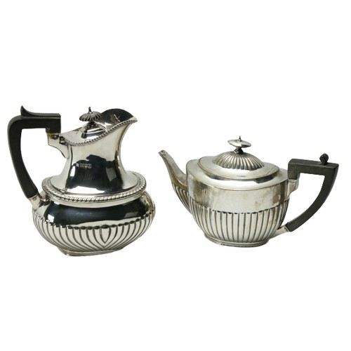 179 - A silver Hot Water Pot, with half reeded oval body and gadroon edge with ebonised wooden handle, 656... 