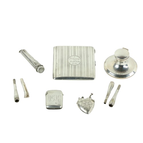 183 - A machine turned silver stamp and Sovereign Purse, Chester 1920, a silver heart shaped Vesta Case, a... 