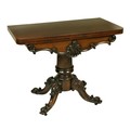 A Victorian fold-over rosewood Card Table, with shaped C scroll and leaf carved frieze on a heavy tu... 