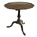 A 19th Century mahogany flip top Table, with circular recurving pie-crust top on baluster pod and tr... 