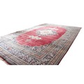 A fine semi-antique burgundy ground Persian Carpet, the large centre medallion with stylized flowers... 